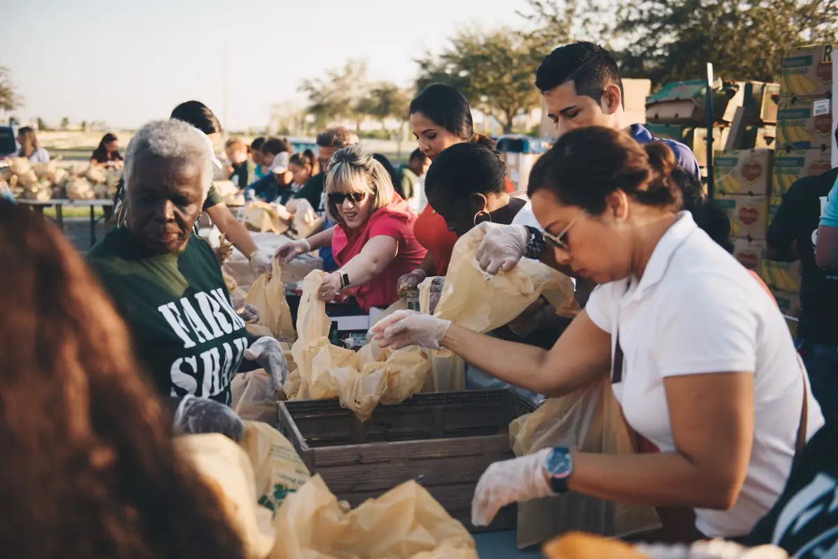 Volunteers packing bags of food at a King Jesus outreach
